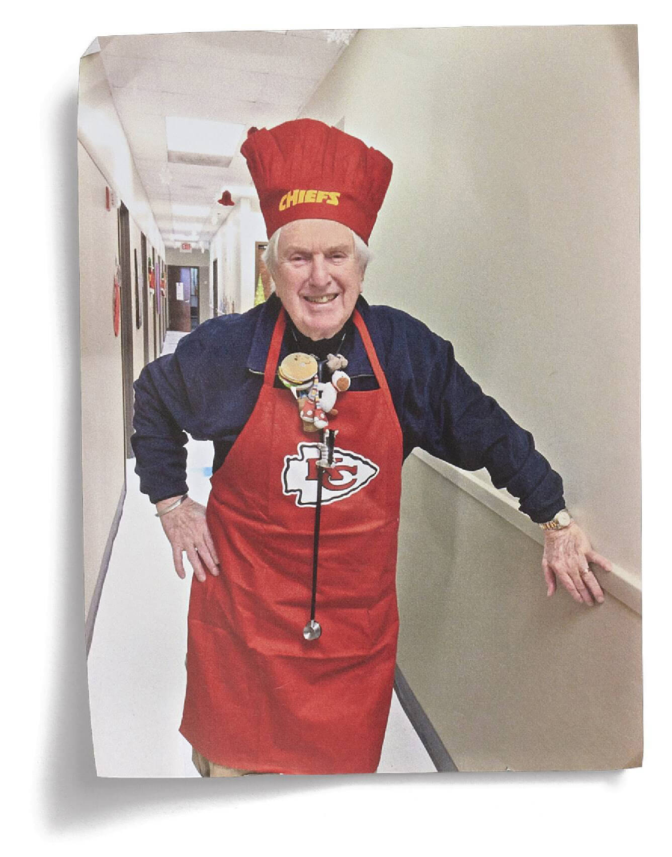 Photograph of Kurt in a pediatrics office dressed up in Chiefs memorabilia 