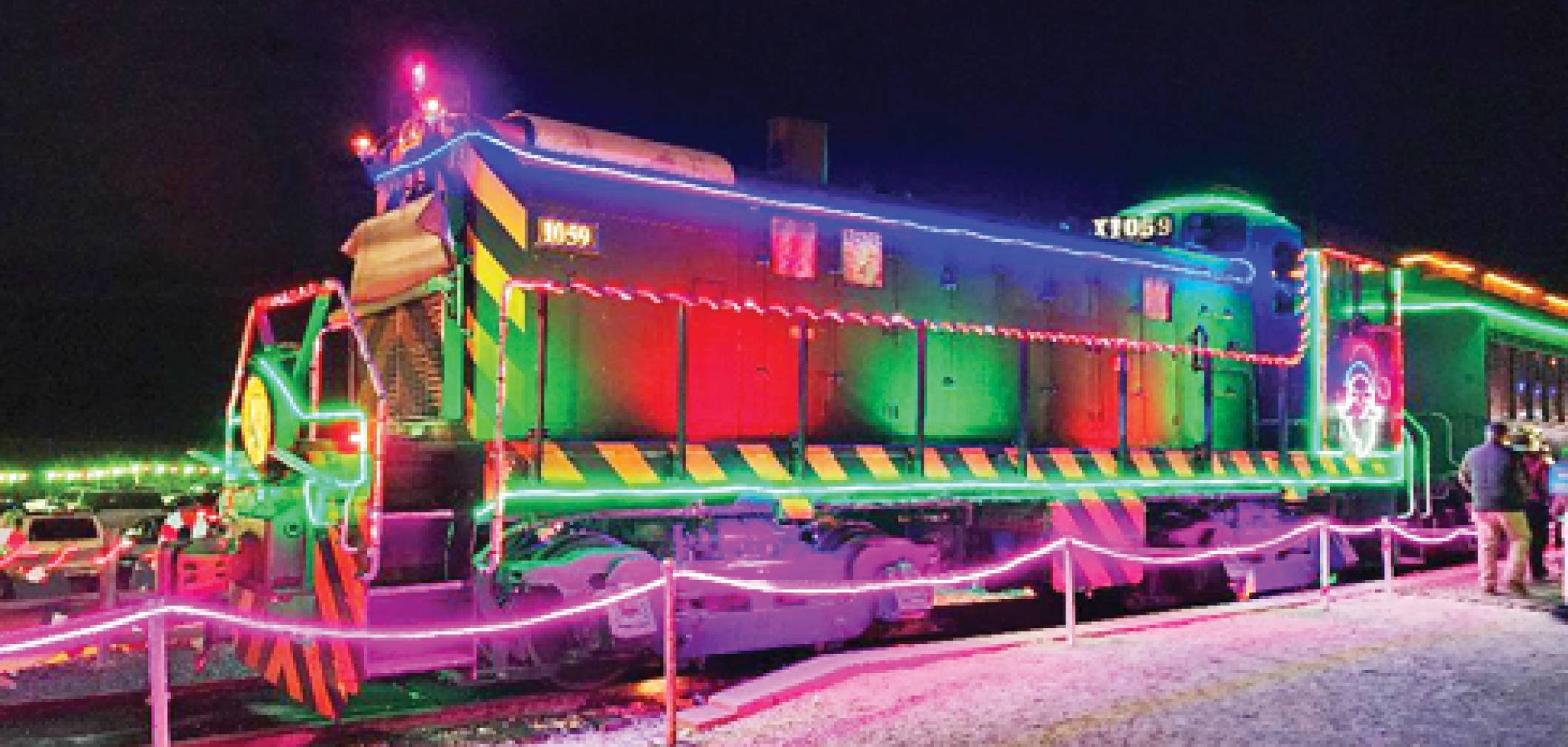 Image of the V&T candy cane express in night. The train is lit up with colorful light