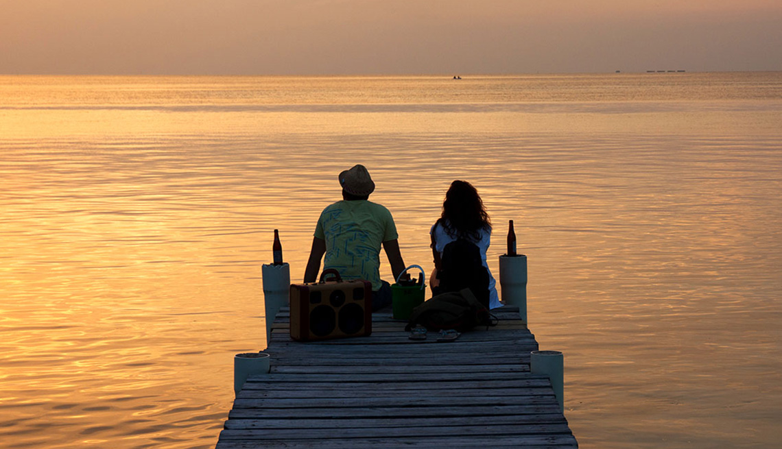 Couple Watch The Sunset On Dock In Belize, Best Honeymoon Destinations