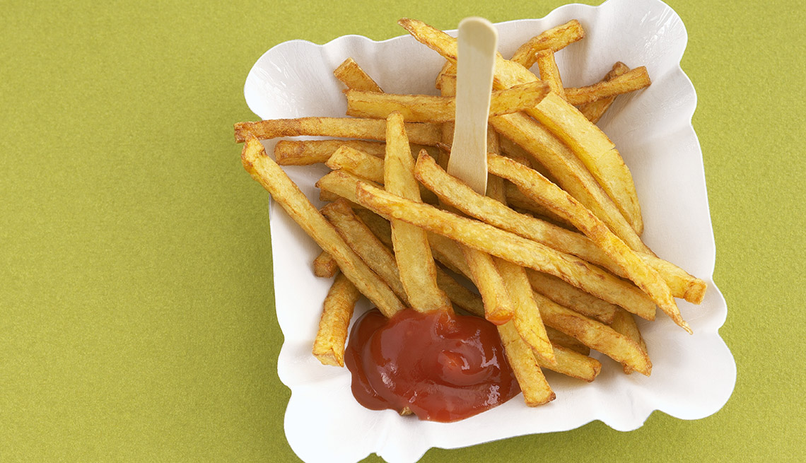 A Plate Of French Fries With Ketchup, Foods To Avoid Before Flying
