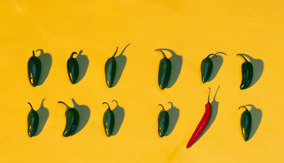A Line Of Hot Peppers And One Lone Red Pepper On Bright Yellow Background, Foods To Avoid Before Flying