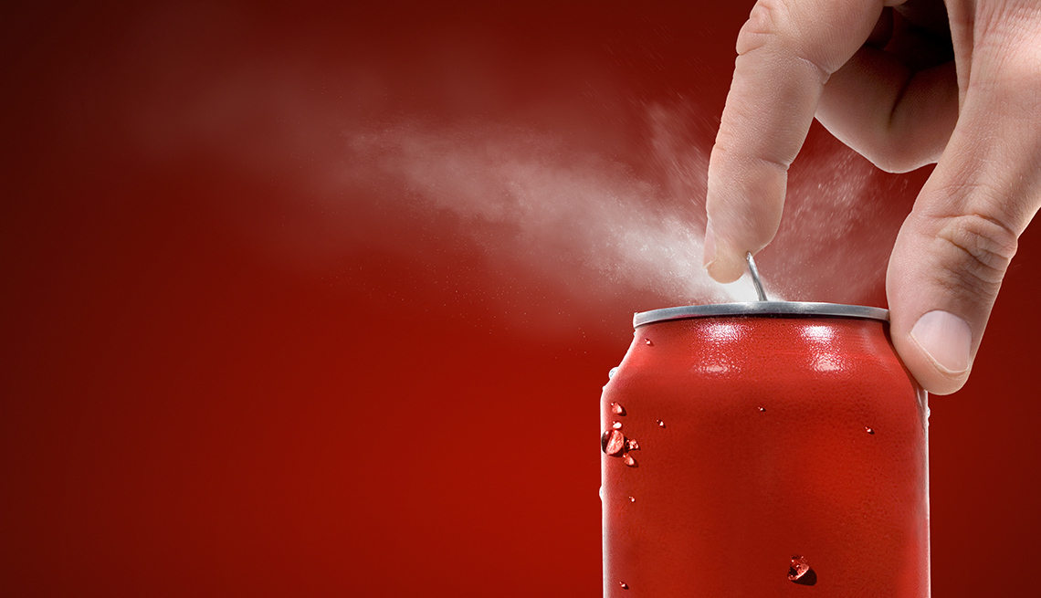 Close Of Man's Hand Opening A Can Of Soda, Foods To Avoid Before Flying