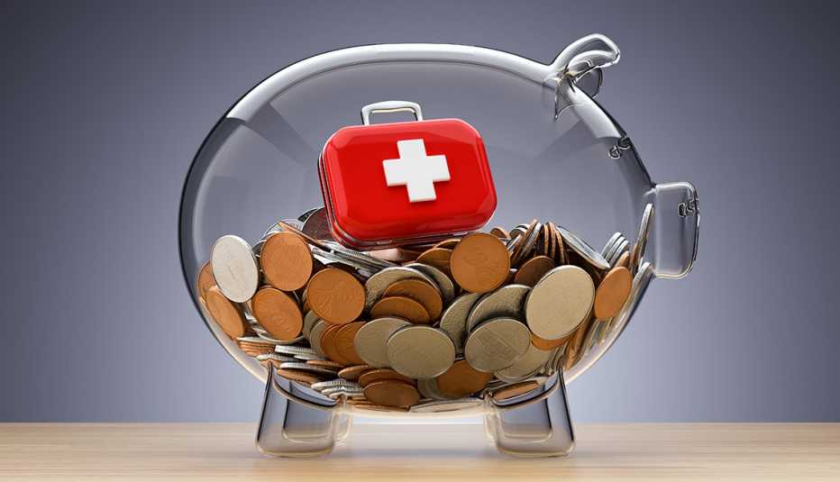 a clear piggy bank with coins and a red suitcase with a white cross on it