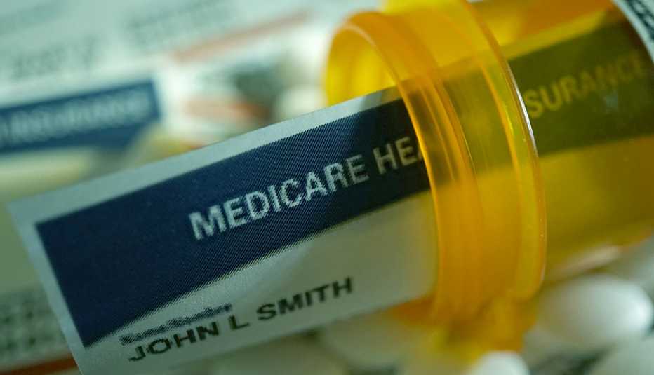 A Medicare card placed inside of a prescription pill bottle