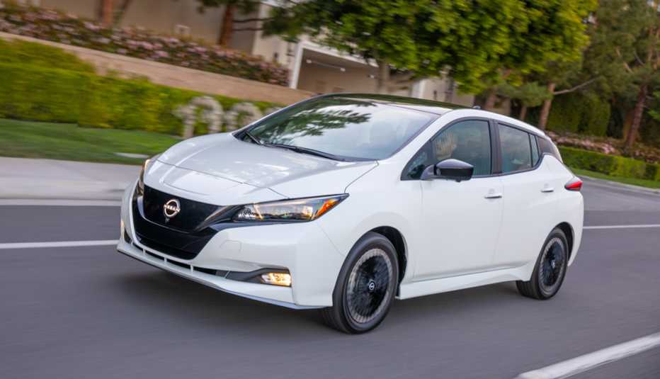 twenty twenty three nissan leaf driving through a neighborhood