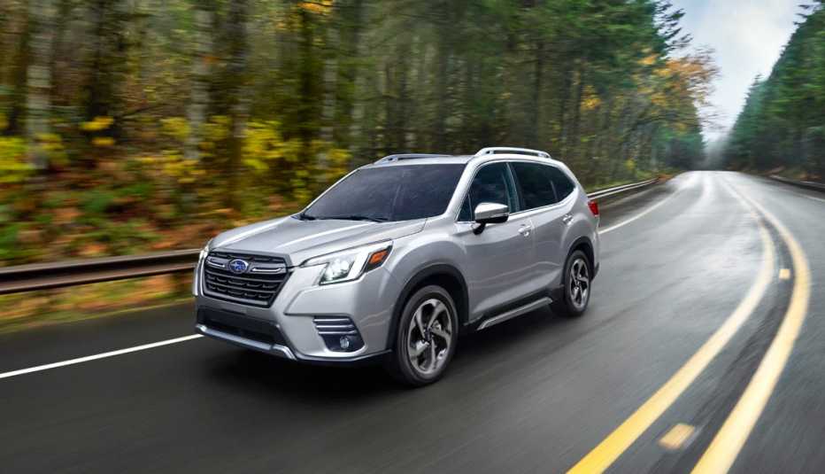 twenty twenty two subaru forester driving through an autumn forest