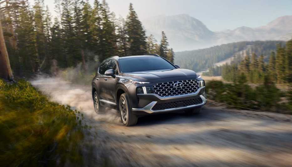 twenty twenty three hyundai santa fe hybrid driving up a mountain dirt road