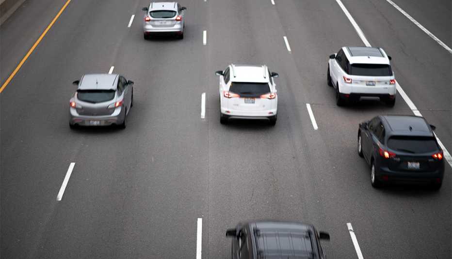 Cars travel in a pack on a major highway / interstate.