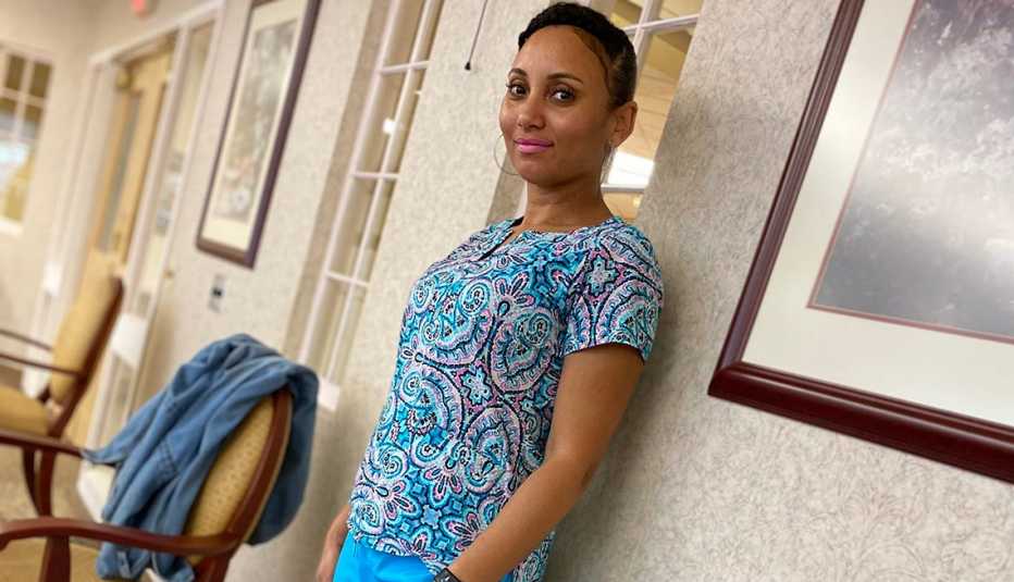 Certified nursing assistant Adelina Ramos standing in the hallway of a nursing home