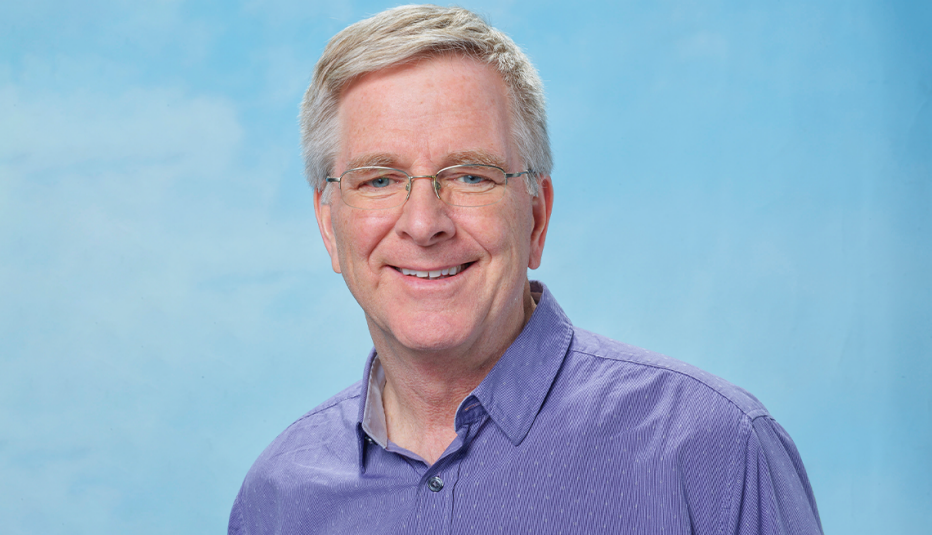 rick steves wearing blue shirt against light blue background