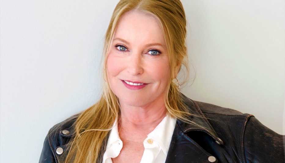 Lisa Swayze poses in a denim jacket 