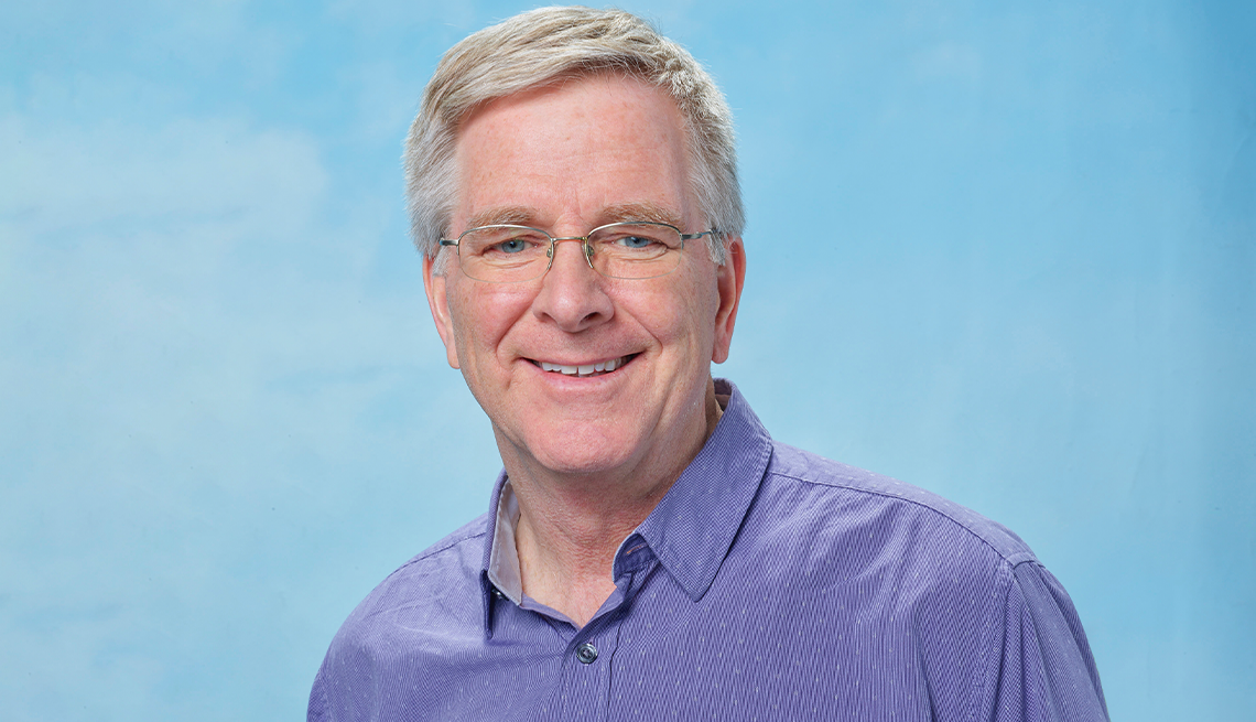 rick steves wearing blue shirt against light blue background