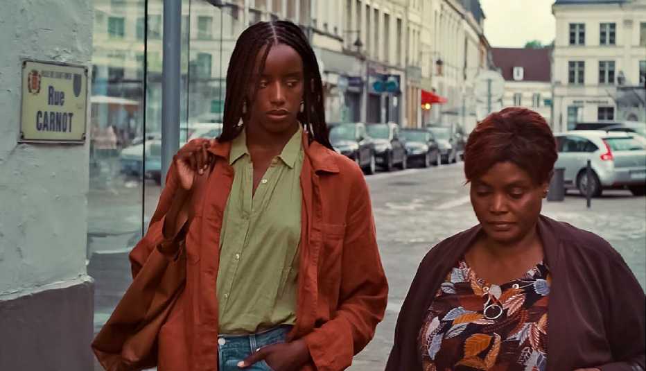 kayije kagame as rama and salimata kamate as odile diata walking down street in still from saint omer

