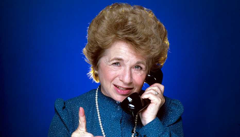 Doctor Ruth talks on a phone