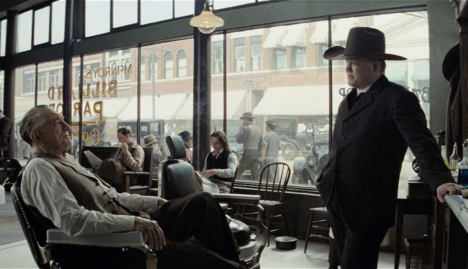 robert de niro sitting in a chair talking to jesse plemons in a scene from the film killers of the flower moon