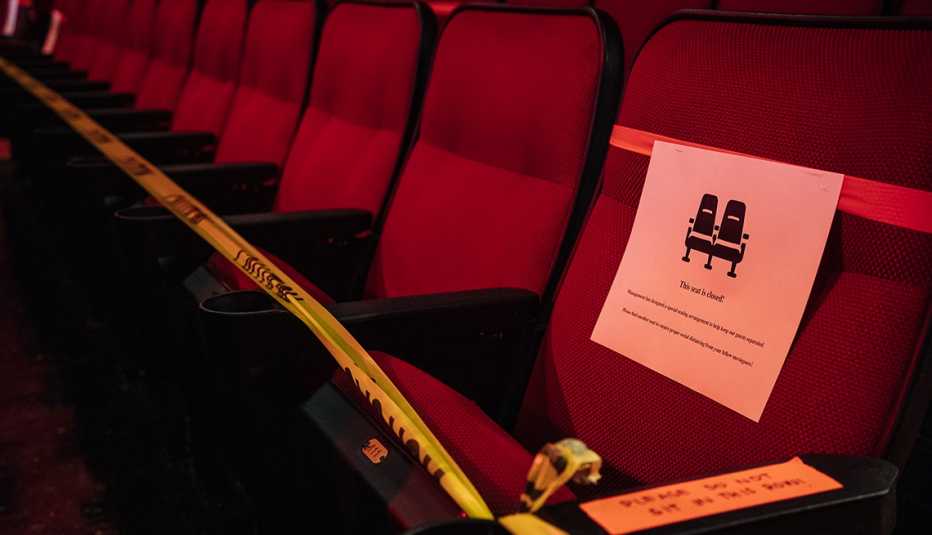 A row of seats sit blocked off at a movie theater
