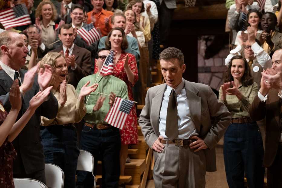cillian murphy in front of a cheering crowd in a scene from the film oppenheimer