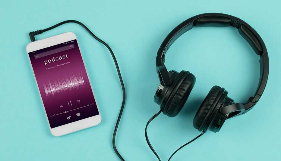 A pair of headphones plugged into a smartphone that is playing a podcast