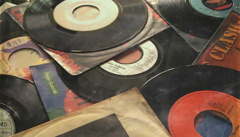 old records out of sleeves laid out in a messy pile