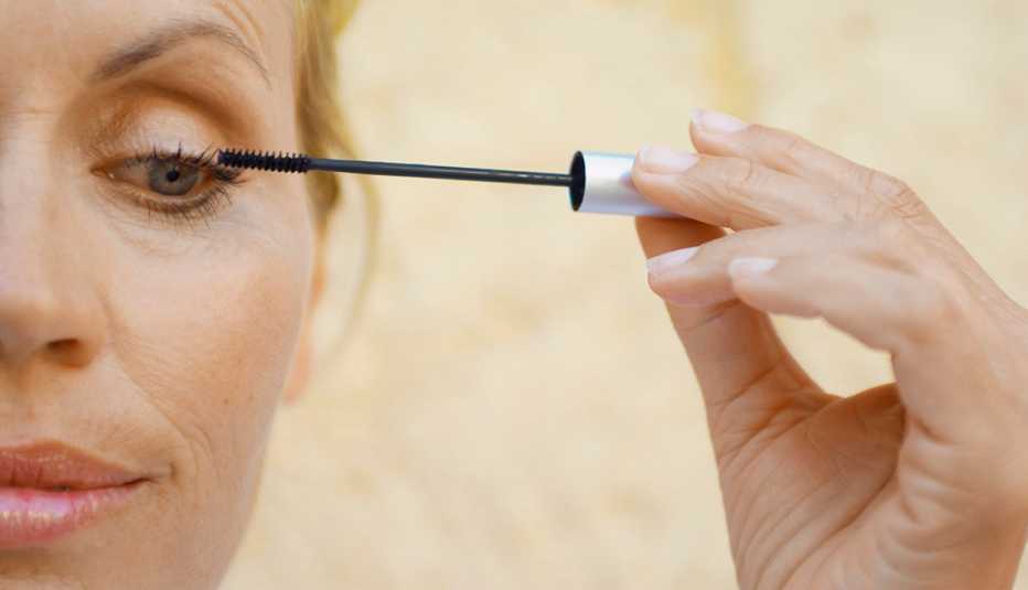 Woman applying mascara
