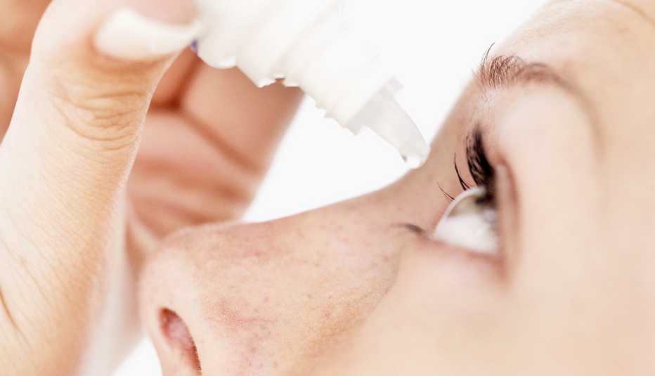 Woman using eye drops