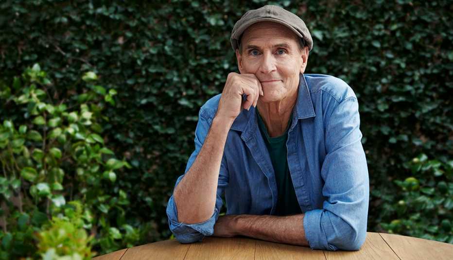 portrait of james taylor smiling sitting outdoors at a table