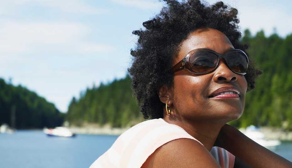 A woman wearing sunglasses on the deck of a yacht
