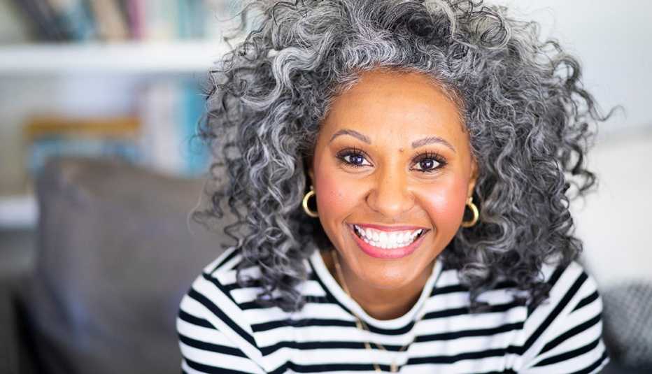 A woman wearing a black and white striped shirt smiling