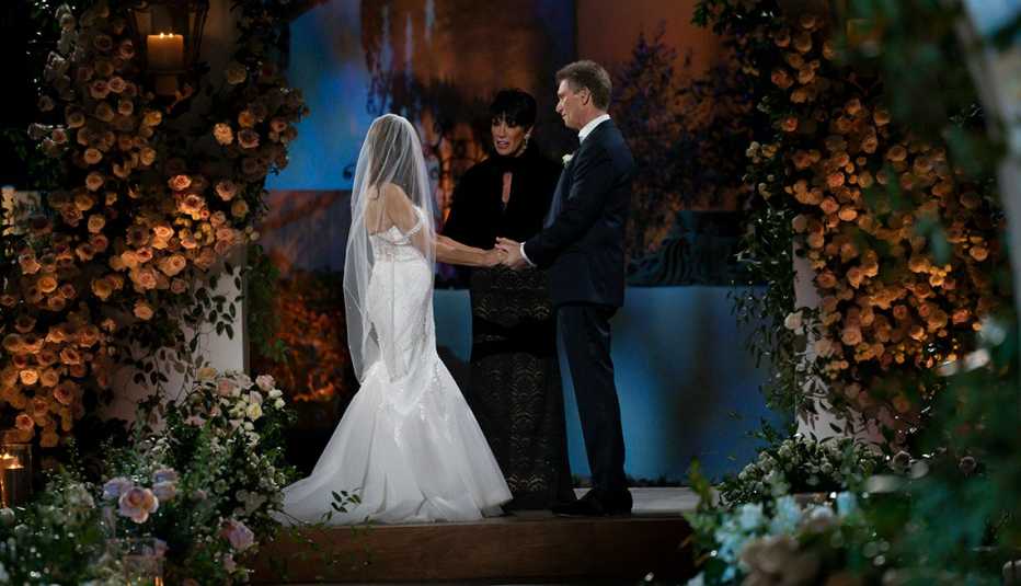 Theresa Nist and Gerry Turner holds hand with Susan Noles officiating the ceremony at "The Golden Wedding."