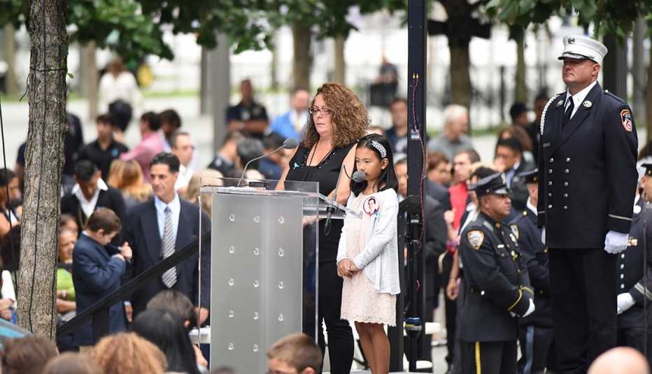 People reading names at a nine eleven memorial service in New York City