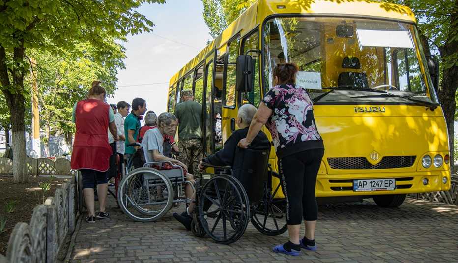 Residents are loaded onto buses. 