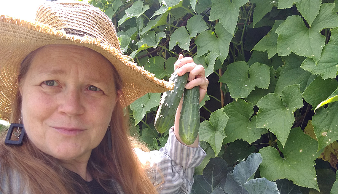 Teresa Konechne in her garden with cucumbers