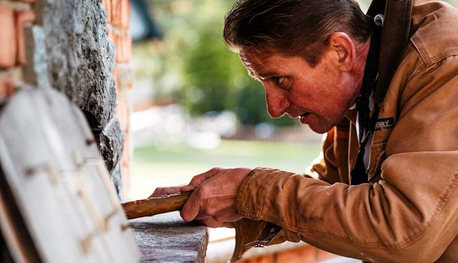 jeff owens checks on bread in his backyard oven