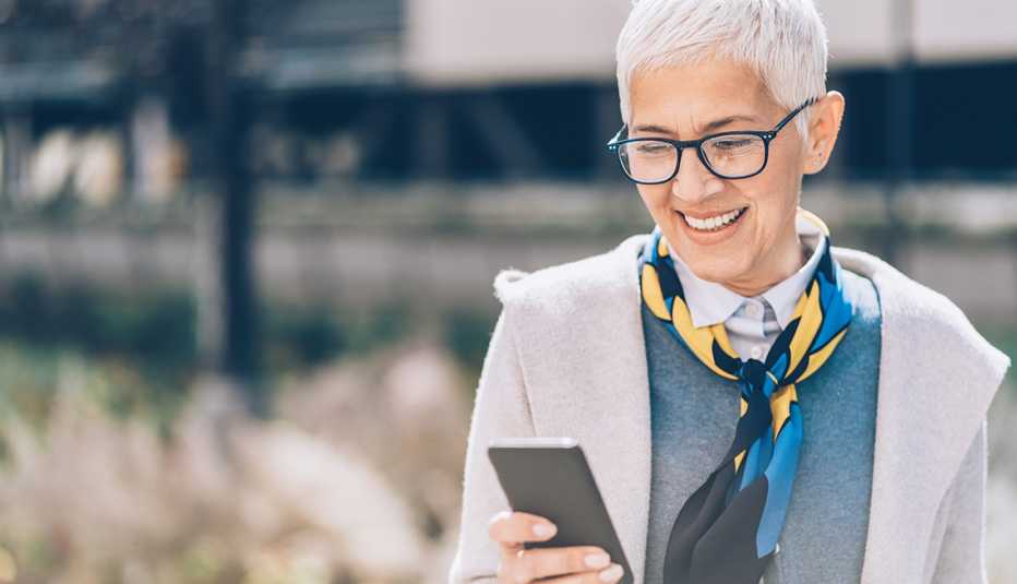 Mature woman smiling at cell phone
