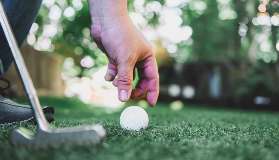 Playing golf in the garden. Sport and workout during work home. 