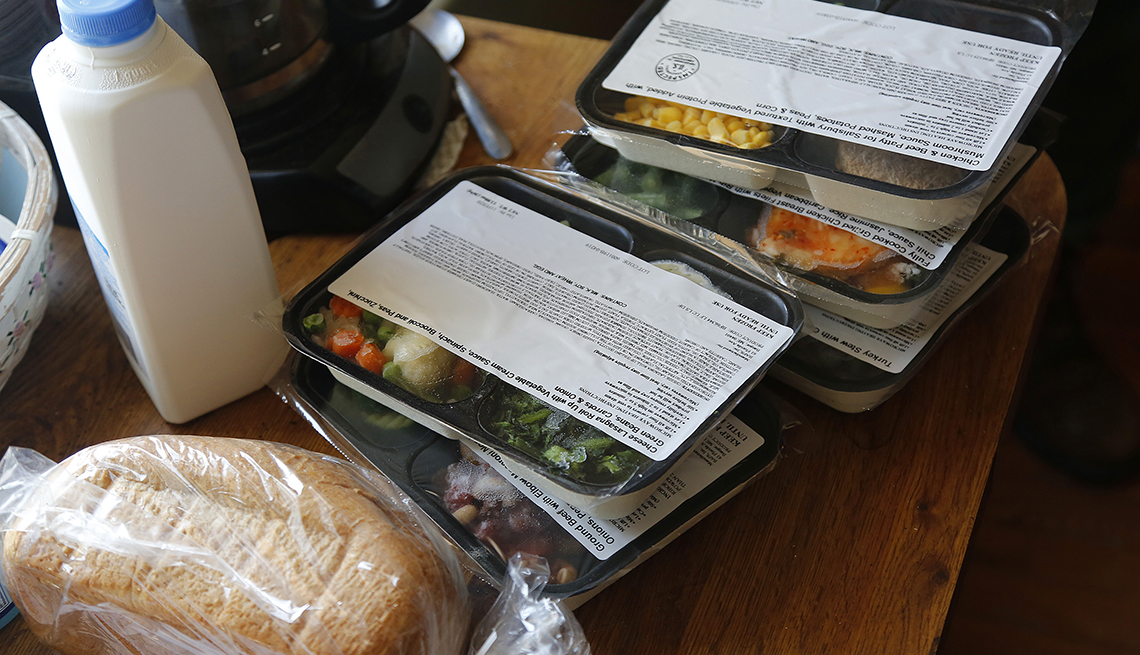 Leonard Guralnick delivers food to Michael Giggey, 55, at his apartment in Portland