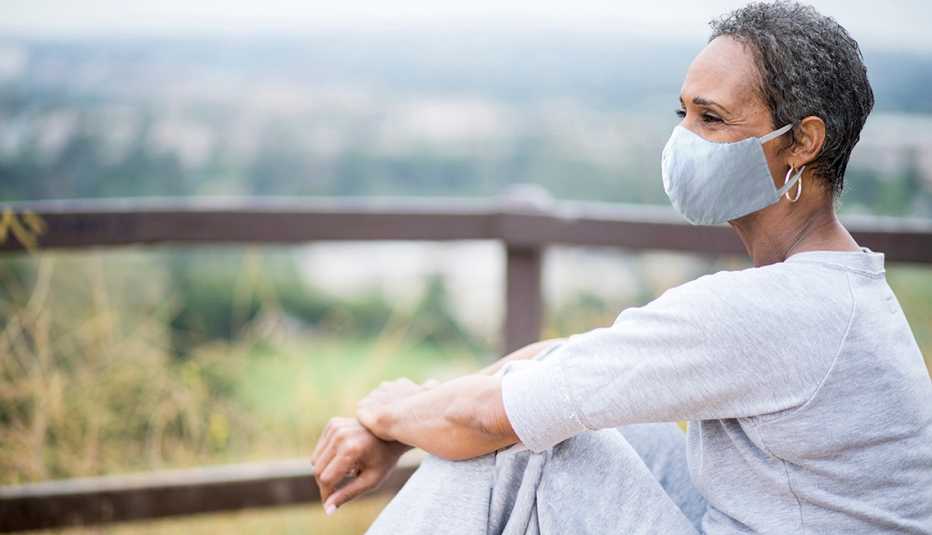 A woman outdoors with a mask