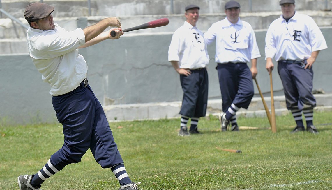 A man swings a bat at a baseball game