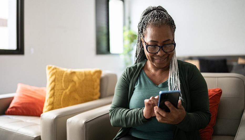 Senior woman playing games on her mobile phone at home