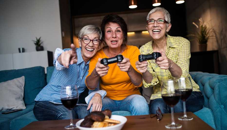 senior women having great time together playing video game