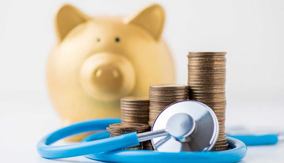 A gold piggy bank with money and a stethoscope