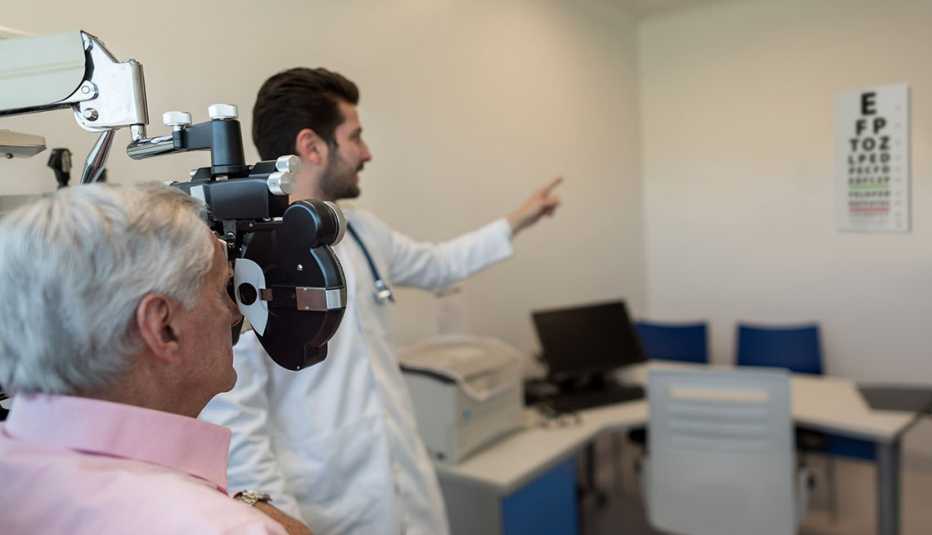 doctor tests patient's vision at an eye exam