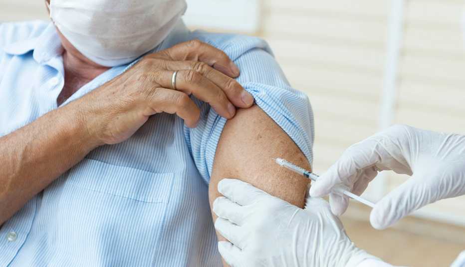 man wearing a protective face mask is getting vaccination