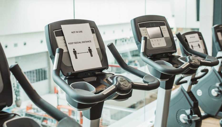 A treadmill with a social distance sign on it