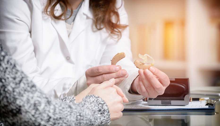 Doctor Shows Hearing Aid to Patient