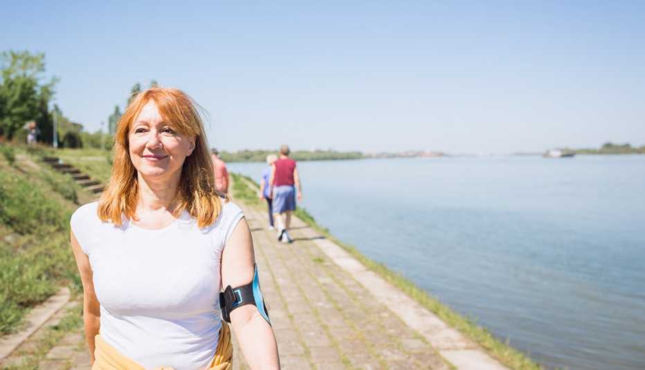 Mature  woman having walking on a trail by water