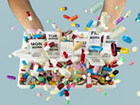Tossing pills in the air from weekly medicine container. Side effects of prescribed drugs.