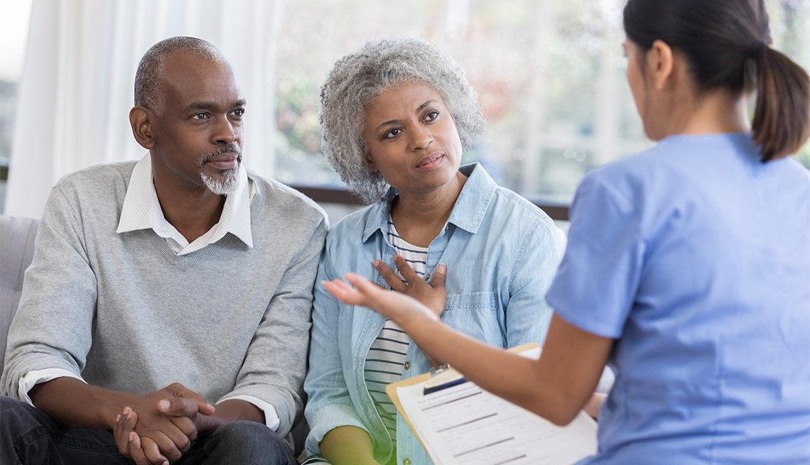 Couple listens to a medical provider. 