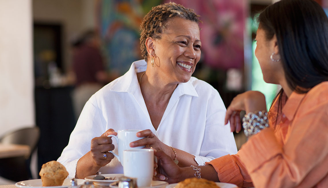 woman chatting with her daughter in a cafe 
