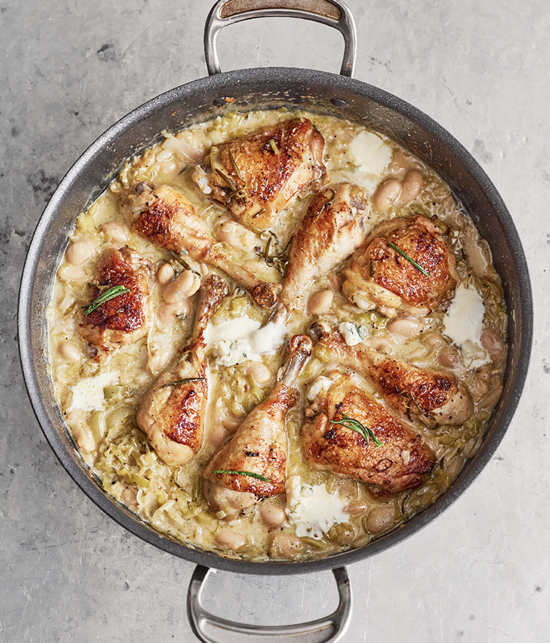 chicken thighs and drumsticks covered in sauce in a pan